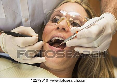 Stock Image - Female patient at dental appointment; Edmonton, Alberta, Canada. Fotosearch