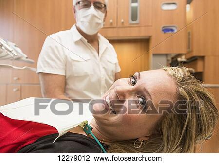 Stock Image - Female patient at dental appointment; Edmonton, Alberta, Canada. Fotosearch