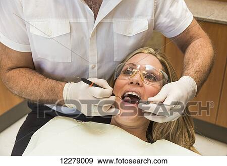 Female patient at dental appointment; Edmonton, Alberta, Canada View Large Photo Image Stock Photo - Female patient at dental appointment; Edmonton, Alberta, Canada. Fotosearch