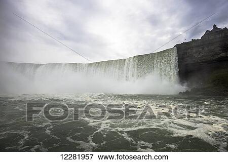 Stock Photo - Foaming water wall of Niagara Falls; Niagara Falls, Ontario, Canada. Fotosearch