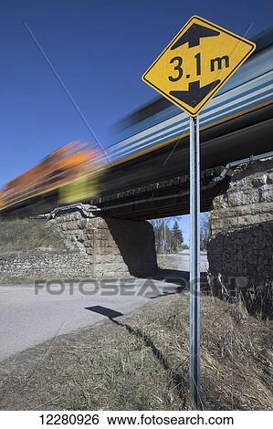 Freight train crossing small bridge, Crewson's Corners, near Acton; Ontario, Canada View Large Photo Image Stock Photograph - Freight train crossing small bridge, Crewson's Corners, near Acton; Ontario, Canada. Fotosearch