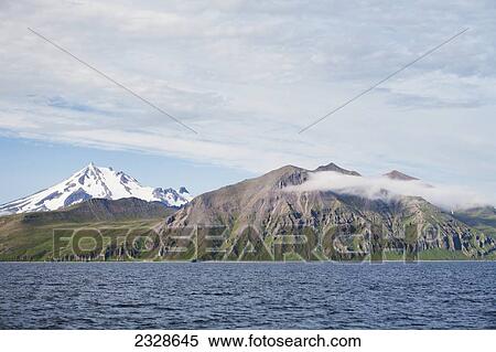 Frosty Volcano And The Alaska Peninsula In The Summer; Southwest Alaska, United States Of America View Large Photo Image Stock Photography - Frosty Volcano And The Alaska Peninsula In The Summer; Southwest Alaska, United States Of America. Fotosearch