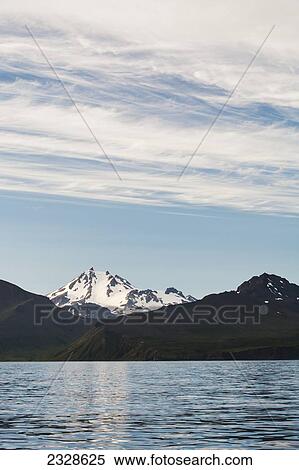 Stock Photography - Frosty Volcano Near Cold Bay On The Alaska Peninsula; Southwest Alaska, United States Of America. Fotosearch