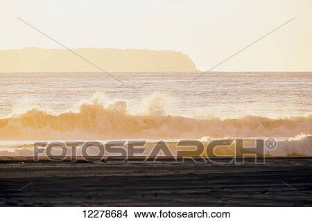 Golden surf visible from Barking Sands Beach in Kekaha with Niihau visible in the distance; Kekaha, Kauai, Hawaii, United States of America View Large Photo Image Picture - Golden surf visible from Barking Sands Beach in Kekaha with Niihau visible in the distance; Kekaha, Kauai, Hawaii, United States of America. Fotosearch
