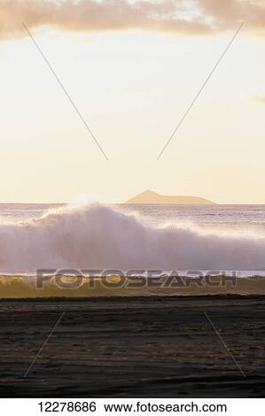 Golden surf visible from Barking Sands Beach in Kekaha with Lehua visible in the distance; Kekaha, Kauai, Hawaii, United States of America View Large Photo Image Stock Photograph - Golden surf visible from Barking Sands Beach in Kekaha with Lehua visible in the distance; Kekaha, Kauai, Hawaii, United States of America. Fotosearch