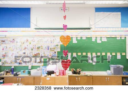 Stock Photo - Hearts Hanging In A Row From A Ceiling In A Classroom; Toronto, Ontario, Canada. Fotosearch