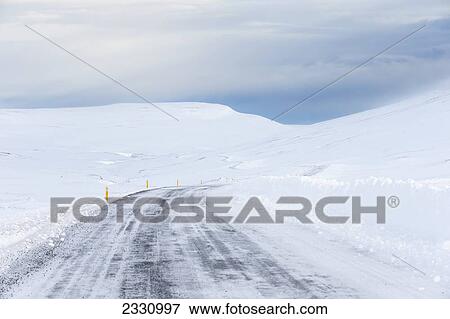 Stock Photo - Highway Weaving Through The Snowy Landscape; Northern Iceland. Fotosearch
