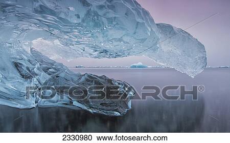 Iceberg On The Beach Along The South Coast Of Iceland With A River Flowing By It Leading Towards The Ocean; Iceland View Large Photo Image Stock Image - Iceberg On The Beach Along The South Coast Of Iceland With A River Flowing By It Leading Towards The Ocean; Iceland. Fotosearch