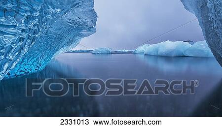 Stock Image - Icebergs Reflected In Tranquil Water; Southern Iceland. Fotosearch