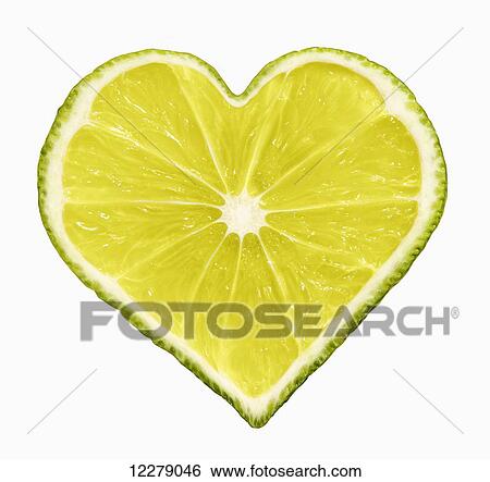 Stock Photograph - Lime cut into the shape of a heart on a white background; Montreal, Quebec, Canada. Fotosearch