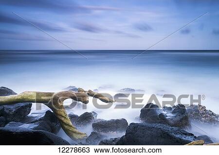 Stock Image - Long exposure of the surf along Wailua Beach; Wailua, Kauai, Hawaii, United States of America. Fotosearch