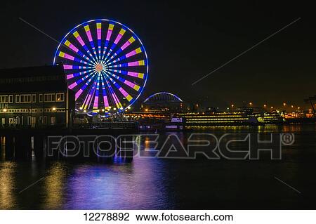 Long exposure photograph showcasing the many color combinations the Big Wheel produces at night; Seattle, Washington, United States of America View Large Photo Image Stock Image - Long exposure photograph showcasing the many color combinations the Big Wheel produces at night; Seattle, Washington, United States of America. Fotosearch