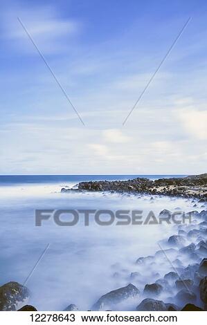 Stock Image - Long exposure surf along the Kealia Beach; Kapaa, Kauai, Hawaii, United States of America. Fotosearch