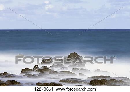 Stock Image - Long exposure surf along the Kealia Beach; Kapaa, Kauai, Hawaii, United States of America. Fotosearch