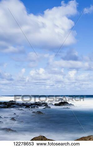 Stock Image - Long exposure surf along the Kealia Beach; Kapaa, Kauai, Hawaii, United States of America. Fotosearch
