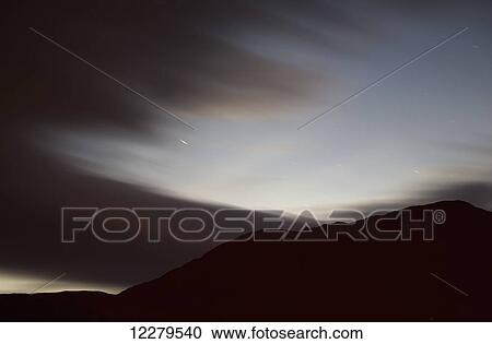 Stock Image - Meteor flashing through the sky; Cumbria, England. Fotosearch