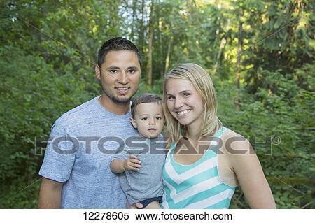 Stock Photography - Mixed race parents with a toddler; Mill Creek, Washington, United States of America. Fotosearch
