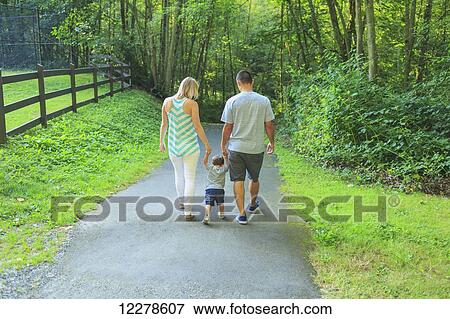 Mixed race parents with a toddler walking on a trail; Mill Creek, Washington, United States of America View Large Photo Image Stock Photo - Mixed race parents with a toddler walking on a trail; Mill Creek, Washington, United States of America. Fotosearch