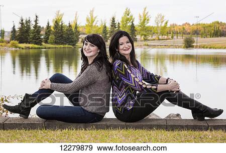 Stock Photo - Mother and daughter posing and spending quality time together in a city park in autumn; St. Albert, Alberta, Canada. Fotosearch