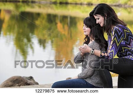 Mother and daughter praying together in a city park in autumn; St. Albert, Alberta, Canada View Large Photo Image Stock Photography - Mother and daughter praying together in a city park in autumn; St. Albert, Alberta, Canada. Fotosearch