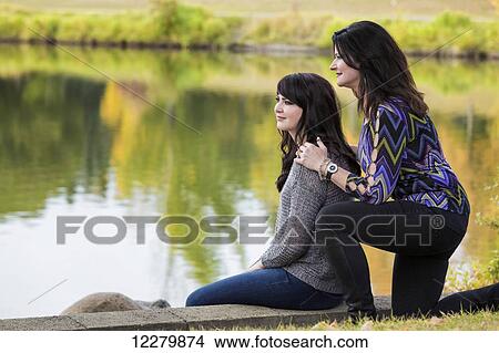 Picture - Mother and daughter spending quality time together in a city park in autumn; St. Albert, Alberta, Canada. Fotosearch