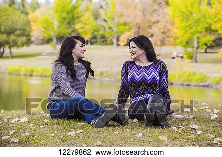 Stock Image - Mother and daughter spending quality time together outdoors in a city park in autumn; St. Albert, Alberta, Canada. Fotosearch