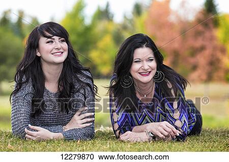 Stock Image - Mother and daughter spending quality time together in a city park in autumn; St. Albert, Alberta, Canada. Fotosearch