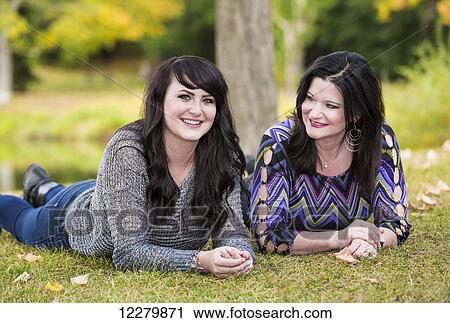 Mother and daughter spending quality time together in a city park in autumn; St. Albert, Alberta, Canada View Large Photo Image Stock Image - Mother and daughter spending quality time together in a city park in autumn; St. Albert, Alberta, Canada. Fotosearch