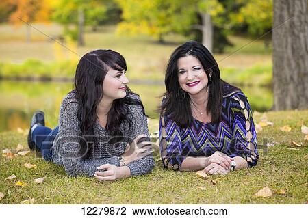 Mother and daughter spending quality time together in a city park in autumn; St. Albert, Alberta, Canada View Large Photo Image Stock Image - Mother and daughter spending quality time together in a city park in autumn; St. Albert, Alberta, Canada. Fotosearch