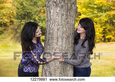 Stock Image - Mother and daughter spending quality time together in a city park in autumn; St. Albert, Alberta, Canada. Fotosearch
