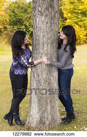 Stock Image - Mother and daughter spending quality time together in a city park in autumn; St. Albert, Alberta, Canada. Fotosearch