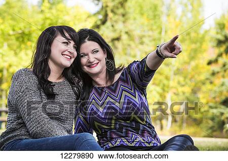 Stock Image - Mother and daughter spending quality time together outdoors in a city park in autumn; St. Albert, Alberta, Canada. Fotosearch