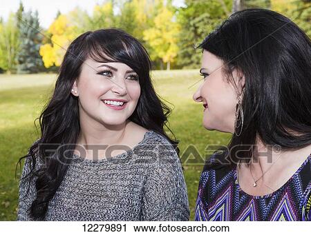 Stock Image - Mother and daughter spending quality time together outdoors in a city park in autumn; St. Albert, Alberta, Canada. Fotosearch
