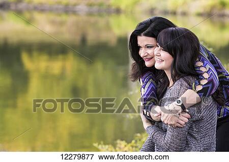 Mother and daughter spending quality time together in a city park in autumn; St. Albert, Alberta, Canada View Large Photo Image Stock Photo - Mother and daughter spending quality time together in a city park in autumn; St. Albert, Alberta, Canada. Fotosearch