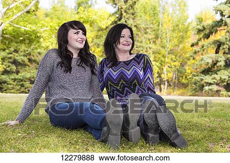 Stock Photo - Mother and daughter spending quality time together outdoors in a city park in autumn; St. Albert, Alberta, Canada. Fotosearch