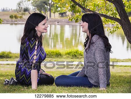 Stock Photography - Mother and daughter spending quality time together outdoors in a city park in autumn; St. Albert, Alberta, Canada. Fotosearch