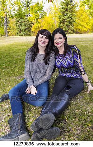 Mother and daughter spending quality time together outdoors in a city park in autumn; St. Albert, Alberta, Canada View Large Photo Image Stock Photography - Mother and daughter spending quality time together outdoors in a city park in autumn; St. Albert, Alberta, Canada. Fotosearch