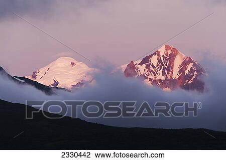 Mountain Peaks Above The Clouds On Hallo Bay, Katmai Naional Park, Alaska Peninsula; Southwest Alaska, United States Of America View Large Photo Image Stock Image - Mountain Peaks Above The Clouds On Hallo Bay, Katmai Naional Park, Alaska Peninsula; Southwest Alaska, United States Of America. Fotosearch