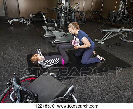 Physiotherapist assisting young woman with spinal cord injury in performing double leg press exercises; Edmonton, Alberta, Canada View Large Photo Image Stock Image - Physiotherapist assisting young woman with spinal cord injury in performing double leg press exercises; Edmonton, Alberta, Canada. Fotosearch