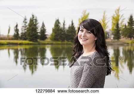 Portrait of a beautiful young woman outdoors in a park in autumn; St. Albert, Alberta, Canada View Large Photo Image Picture - Portrait of a beautiful young woman outdoors in a park in autumn; St. Albert, Alberta, Canada. Fotosearch