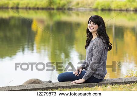 Portrait of a beautiful young woman outdoors in a park in autumn; St. Albert, Alberta, Canada View Large Photo Image Stock Image - Portrait of a beautiful young woman outdoors in a park in autumn; St. Albert, Alberta, Canada. Fotosearch