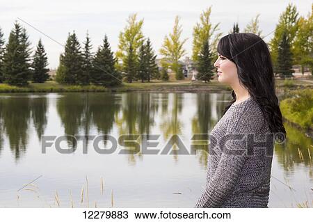 Portrait of a beautiful young woman outdoors in a park in autumn; St. Albert, Alberta, Canada View Large Photo Image Stock Image - Portrait of a beautiful young woman outdoors in a park in autumn; St. Albert, Alberta, Canada. Fotosearch