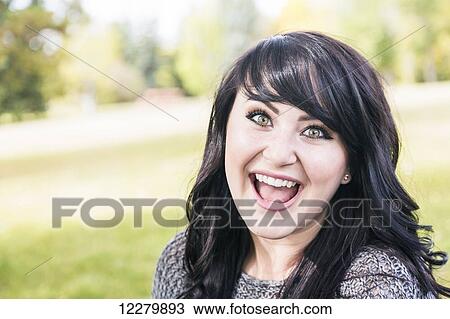 Stock Image - Portrait of a beautiful young woman outdoors in a park in autumn; St. Albert, Alberta, Canada. Fotosearch