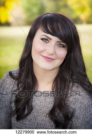 Portrait of a beautiful young woman outdoors in a city park in autumn; St. Albert, Alberta, Canada View Large Photo Image Stock Image - Portrait of a beautiful young woman outdoors in a city park in autumn; St. Albert, Alberta, Canada. Fotosearch