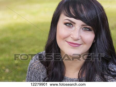 Portrait of a beautiful young woman outdoors in a city park in autumn; St. Albert, Alberta, Canada View Large Photo Image Stock Image - Portrait of a beautiful young woman outdoors in a city park in autumn; St. Albert, Alberta, Canada. Fotosearch