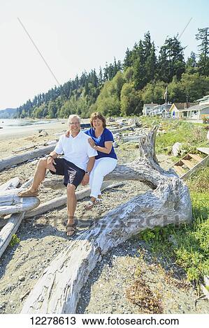 Stock Image - Portrait of a couple on a beach; Whidbey Island, Washington, United States of America. Fotosearch