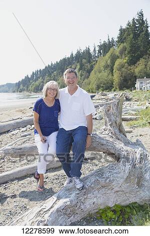 Stock Photo - Portrait of a couple on a beach; Whidbey Island, Washington, United States of America. Fotosearch