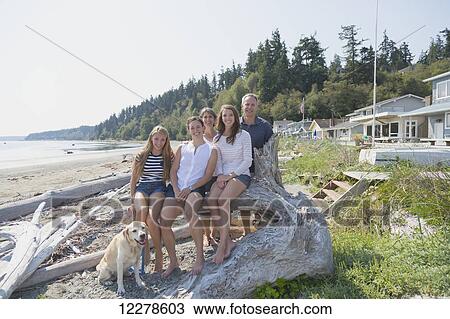 Stock Image - Portrait of a family on the beach; Whidbey Island, Washington, United States of America. Fotosearch