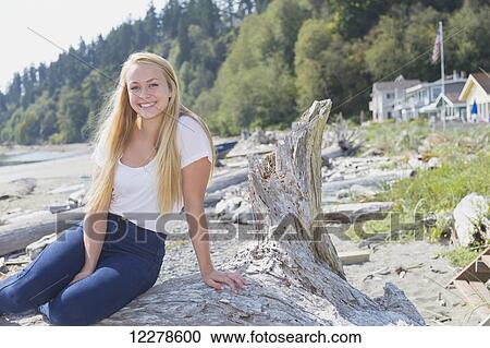 Portrait of a young woman on a beach; Whidbey Island, Washington, United States of America View Large Photo Image Stock Image - Portrait of a young woman on a beach; Whidbey Island, Washington, United States of America. Fotosearch