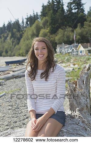 Stock Image - Portrait of a young woman on the beach; Whidbey Island, Washington, United States of America. Fotosearch